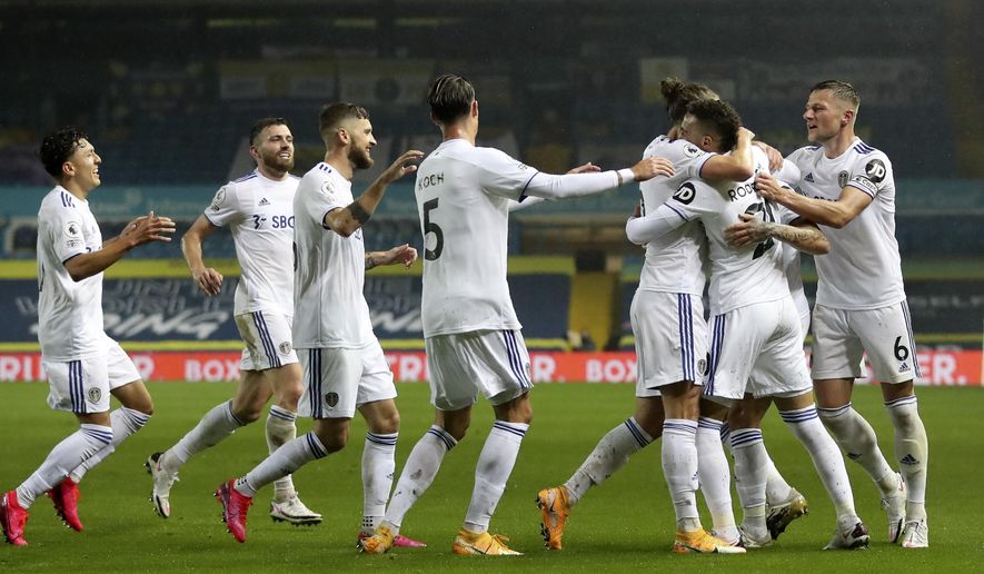 Leeds United's Rodrigo, 2nd right, celebrates after scoring his side's first goal during the English Premier League soccer match between Leeds United and Manchester City at Elland Road in Leeds, England, Saturday, Oct. 3, 2020. (Cath Ivill/Pool via AP)