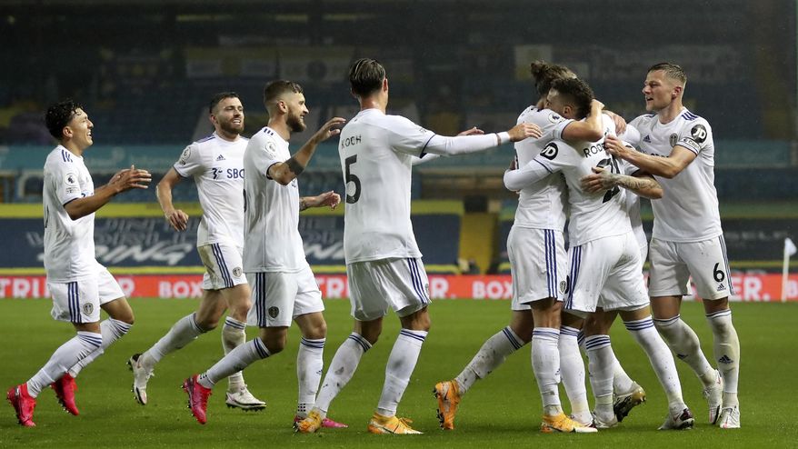 Leeds United's Rodrigo, 2nd right, celebrates after scoring his side's first goal during the English Premier League soccer match between Leeds United and Manchester City at Elland Road in Leeds, England, Saturday, Oct. 3, 2020. (Cath Ivill/Pool via AP)