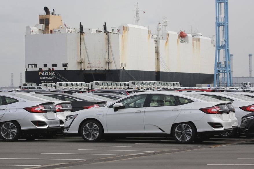 Cars are parked to be exported at Yokohama port, near Tokyo on Sept. 29, 2020. The drop in Japanese exports diminished last month, according to government data released Monday, Oct. 10, 2020, underlining how the blunt of the trade damage from the coronavirus pandemic may be gradually easing. (AP Photo/Koji Sasahara)