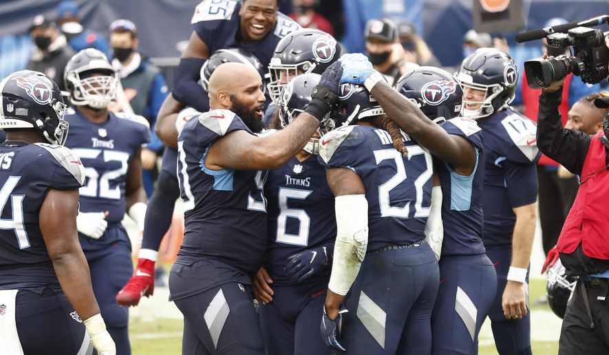 Tennessee Titans running back Derrick Henry (22) is mobbed by teammates after Henry scored the winning touchdown against the Houston Texans in overtime of an NFL football game Sunday, Oct. 18, 2020, in Nashville, Tenn. The Titans won 42-36. (AP Photo/Wade Payne)