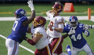 Washington Football Team offensive guard Wes Schweitzer (71) blocks New York Giants&#39; Dexter Lawrence (97) as quarterback Kyle Allen (8) throws a pass during the first half of an NFL football game Sunday, Oct. 18, 2020, in East Rutherford, N.J. (AP Photo/John Minchillo)