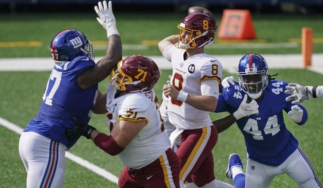 Washington Football Team offensive guard Wes Schweitzer (71) blocks New York Giants&#x27; Dexter Lawrence (97) as quarterback Kyle Allen (8) throws a pass during the first half of an NFL football game Sunday, Oct. 18, 2020, in East Rutherford, N.J. (AP Photo/John Minchillo)