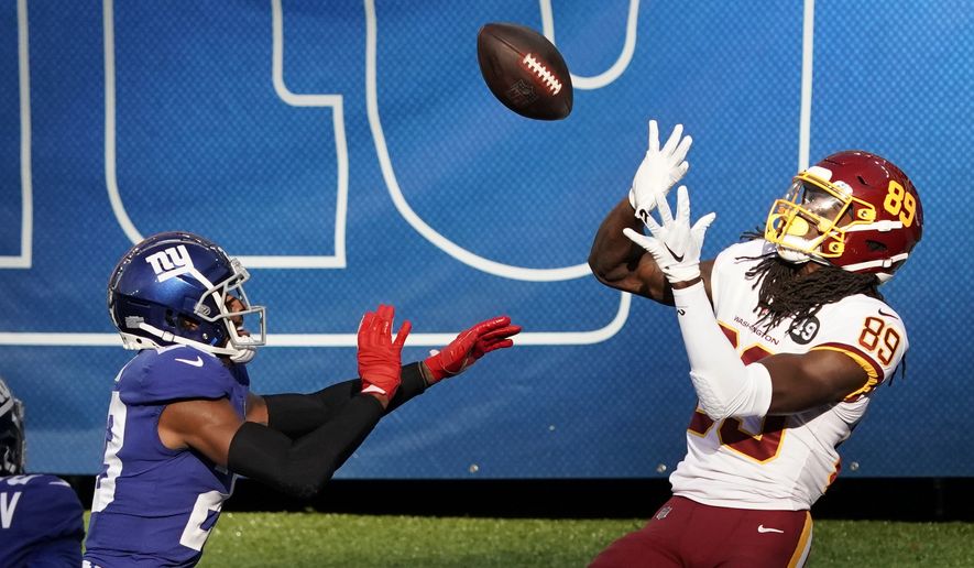 Washington Football Team wide receiver Cam Sims (89) catches a pass for a touchdown in front of New York Giants' Logan Ryan (23) during the second half of an NFL football game Sunday, Oct. 18, 2020, in East Rutherford, N.J. The Giants won 20-19. (AP Photo/Bill Kostroun) **FILE**