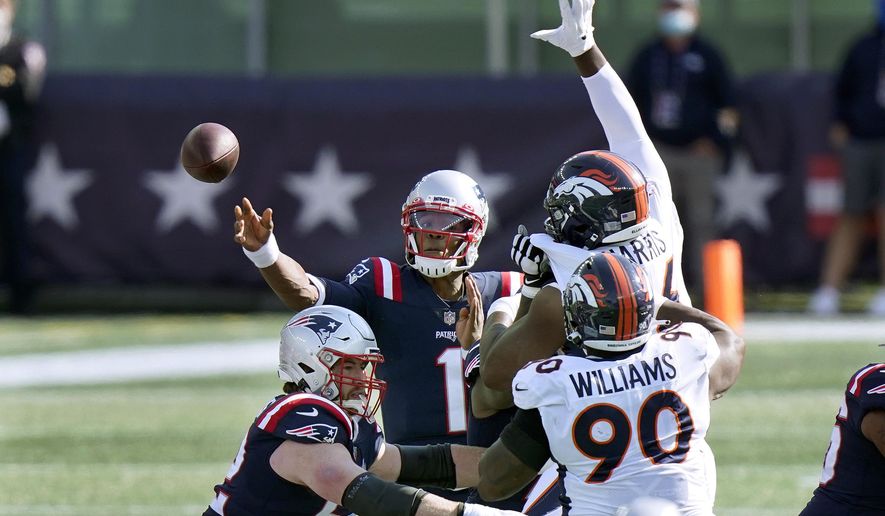 New England Patriots quarterback Cam Newton (1) passes under pressure from Denver Broncos defenders Shelby Harris, right rear, and DeShawn Williams (90) in the first half of an NFL football game, Sunday, Oct. 18, 2020, in Foxborough, Mass. (AP Photo/Steven Senne)