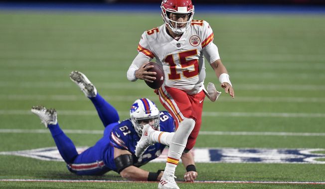 Kansas City Chiefs quarterback Patrick Mahomes (15) evades Buffalo Bills&#x27; Justin Zimmer during the second half of an NFL football game, Monday, Oct. 19, 2020, in Orchard Park, N.Y. (AP Photo/Adrian Kraus)