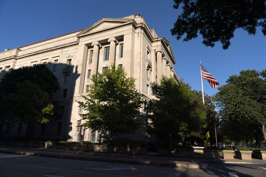 The American flag flies outside of the Justice Department building, Thursday, Oct. 8, 2020, in Washington. (AP Photo/Jacquelyn Martin)  **FILE**