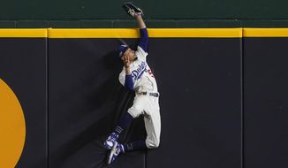 Los Angeles Dodgers right fielder Mookie Betts robs Atlanta Braves&#39; Freddie Freeman of a home run during the fifth inning in Game 7 of a baseball National League Championship Series Sunday, Oct. 18, 2020, in Arlington, Texas. (AP Photo/Tony Gutierrez)