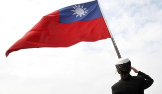 In this Jan. 31, 2018, file photo, a Taiwanese military officer salutes to Taiwan&#39;s flag onboard Navy&#39;s 124th fleet Lafayette frigate during military exercises off Kaohsiung, southern of Taiwan.   (AP Photo/Chiang Ying-ying, File)  **FILE**