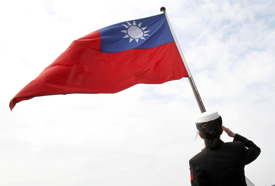 In this Jan. 31, 2018, file photo, a Taiwanese military officer salutes to Taiwan&#x27;s flag onboard Navy&#x27;s 124th fleet Lafayette frigate during military exercises off Kaohsiung, southern of Taiwan.   (AP Photo/Chiang Ying-ying, File)  **FILE**