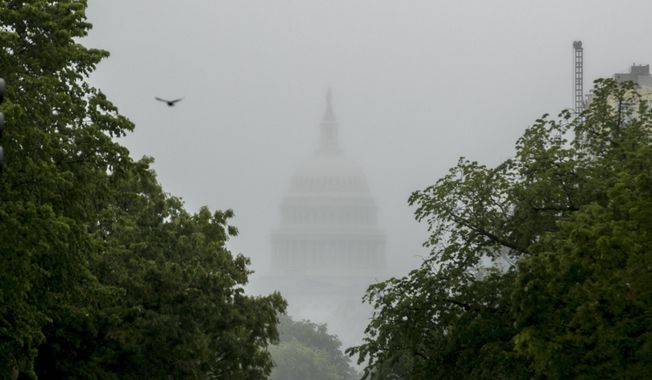 In this May 22, 2020, photo, the dome of the U.S. Capitol Building is visible through heavy fog in Washington. New virus relief will have to wait until after the November election. Congress is past the point at which it can deliver more coronavirus aid soon, with differences between House Speaker Nancy Pelosi, Senate Republicans and President Donald Trump proving insurmountable. (AP Photo/Andrew Harnik) **FILE**