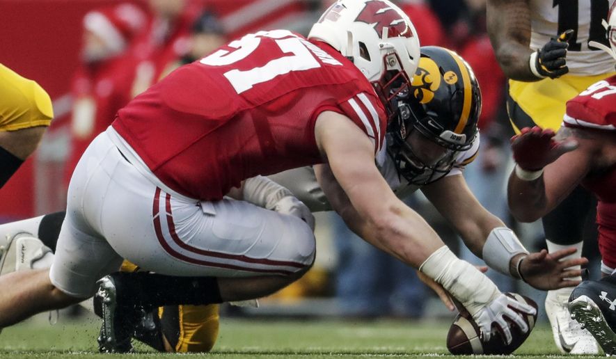 FILE - In this Nov. 9, 2019, file photo, Wisconsin's Jack Sanborn recovers a fumble in front of Iowa's Nate Stanley during the first half of an NCAA college football game in Madison, Wis. Wisconsin traditionally wins games primarily because of its running game and defense. Now that Jonathan Taylor has moved on to the NFL, that would seem to put more pressure on the defense to carry the load as the Badgers’ offense adjusts to life without the two-time Doak Walker Award winner. The defense looks forward to that challenge. (AP Photo/Morry Gash, File)