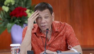 In this photo provided by the Malacanang Presidential Photographers Division, Philippine President Rodrigo Duterte attends a meeting at the Malacanang presidential palace in Manila, Philippines on Monday Oct. 19, 2020. The Philippine president has said he could be held responsible for the thousands of killings under his anti-drugs crackdown and was ready to face charges, except crimes against humanity, that could land him in jail. (Robinson Ninal Jr./Malacanang Presidential Photographers Division via AP)