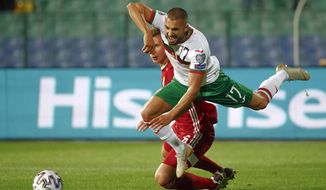 Bulgaria&#39;s Georgi Yomov, right, falls after a tackle by Hungary&#39;s Willi Orban during the Euro 2020 playoff semifinal soccer match between Bulgaria and Hungary at the Vasil Levski stadium in Sofia, Bulgaria, on Thursday Oct. 8, 2020. (AP Photo/Desislava Komarova)