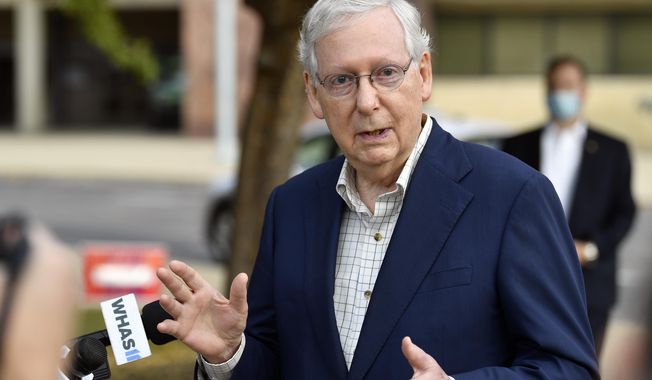 Senate Majority Leader Mitch McConnell, R-Ky., speaks to reporters after casting his vote in the 2020 general election at the Kentucky Exhibition Center in Louisville, Ky., Thursday, Oct. 15, 2020. (AP Photo/Timothy D. Easley)