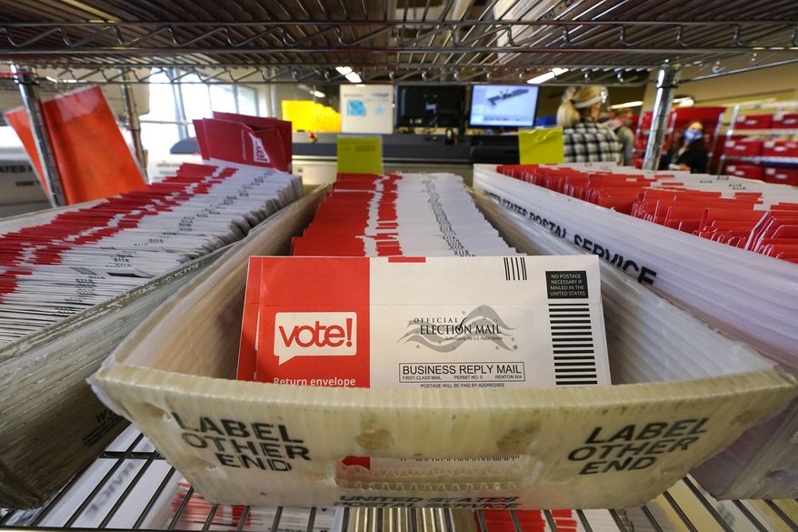 Ballots mailed-in are ready to be sorted at the King County Elections office Tuesday, Oct. 20, 2020, in Renton, Wash. Election officials there said that 280,000 county ballots had already been returned, nearly 20% of the total sent to voters. Washington state is one of five states, along with Colorado, Hawaii, Oregon, and Utah, that conduct elections entirely by mail-in voting. (AP Photo/Elaine Thompson)
