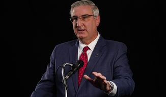Indiana Republican Gov. Eric Holcomb participates in the Indiana Gubernatorial debate with Democrat Woody Myers and Libertarian Donald Rainwater, Tuesday, Oct. 20, 2020, in Indianapolis. The candidates were in separate studios to allow for social distancing guidelines. (AP Photo/Darron Cummings)