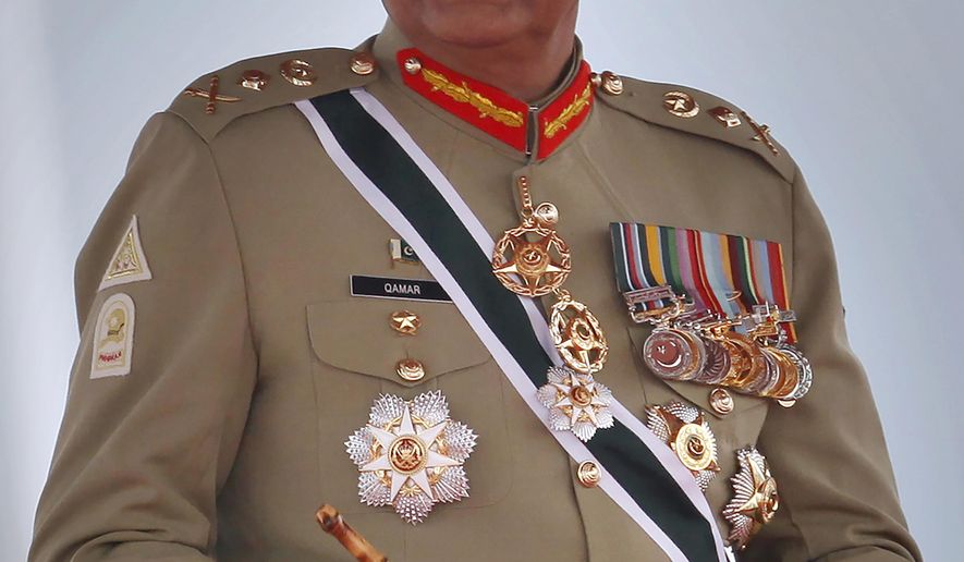 FILE - In this March 23, 2019, file photo, Pakistan&#39;s Army Chief Gen. Qamar Javed Bajwa attends a military parade in Islamabad, Pakistan. Pakistan&#39;s army chief Tuesday, Oct. 20, 2020, ordered an investigation into allegations that a provincial police chief was kidnapped by army troops to force him to order the arrest of the son-in-law of exiled former prime minister Nawaz Sharif. (AP Photo/Anjum Naveed, File)