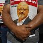 People hold posters of slain Saudi journalist Jamal Khashoggi, near the Saudi Arabia consulate in Istanbul, marking the two-year anniversary of his death, Friday, Oct. 2, 2020. The gathering was held outside the consulate building, starting at 1:14 p.m. (1014 GMT) marking the time Khashoggi walked into the building where he met his demise. The posters read in Arabic:&#39; Khashoggi&#39;s Friends Around the World&#39;. (AP Photo/Emrah Gurel)