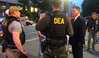 In this Wednesday, June 3, 2020, photo Acting Drug Enforcement Administrator Timothy Shea, right, visits with DEA agents at a checkpoint in Washington. More than 1,500 people have been arrested in the last three months as part of a Drug Enforcement Administration project focusing on violent crime. The initiative, nicknamed Project Safeguard, comes as President Donald Trump has touted similar operations as a much-needed answer to a spike in crime. It&#39;s also to showcase what he says is his law-and-order prowess, claiming he’s countering rising crime in cities run by Democrats. Acting DEA Administrator Tim Shea tells the AP that since the operation launched in August, 1,521 people have been arrested in both state and federal cases in cities across the U.S. and 2,135 firearms have been seized.   (AP Photo/Mike Balsamo)