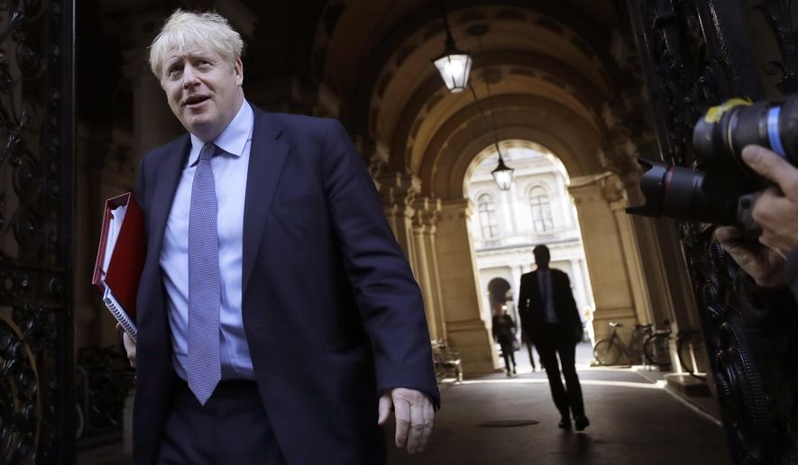 Britain's Prime Minister Boris Johnson returns to Downing Street after attending a Cabinet meeting in London, Tuesday, Oct. 20, 2020. (AP Photo/Kirsty Wigglesworth)