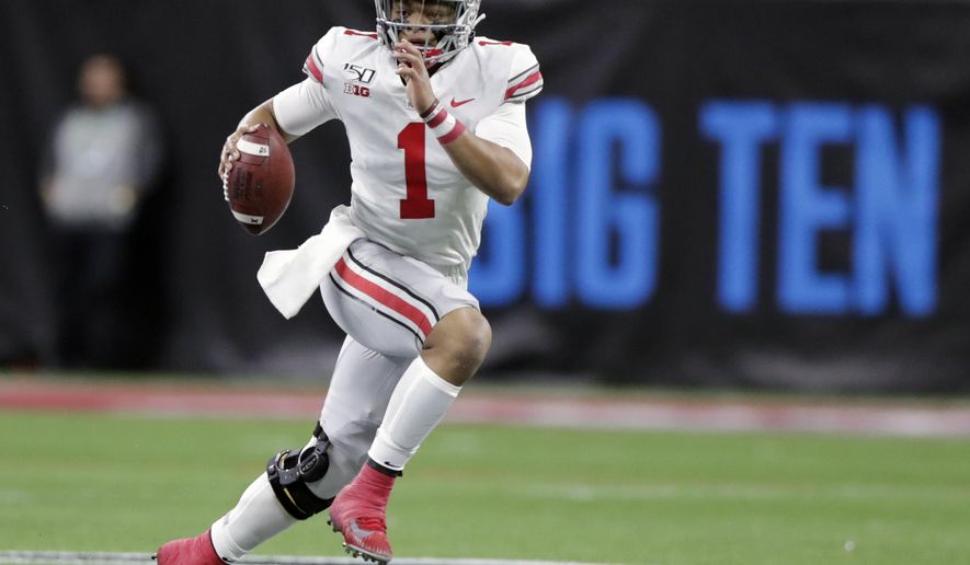 FILE - In this Dec. 7, 2019, file photo, Ohio State quarterback Justin Fields (1) runs with the ball against Wisconsin during the first half of the Big Ten championship NCAA college football game, in Indianapolis. The ACC, Big 12 and SEC have been playing anywhere from three to five weeks amid the pandemic, and all the players and coaches around the Big Ten could do is watch.“Most of it's been torture, just not being able to play games,” Ohio State coach Ryan Day said. (AP Photo/Michael Conroy, File)