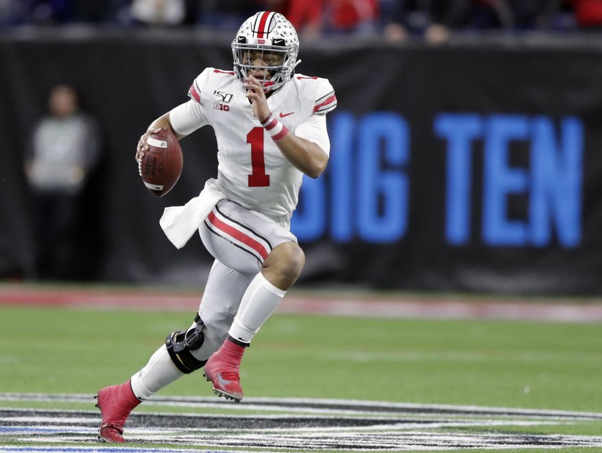 FILE - In this Dec. 7, 2019, file photo, Ohio State quarterback Justin Fields (1) runs with the ball against Wisconsin during the first half of the Big Ten championship NCAA college football game, in Indianapolis. The ACC, Big 12 and SEC have been playing anywhere from three to five weeks amid the pandemic, and all the players and coaches around the Big Ten could do is watch.“Most of it's been torture, just not being able to play games,” Ohio State coach Ryan Day said. (AP Photo/Michael Conroy, File)