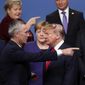 In this Dec. 4, 2019, file photo, NATO Secretary-General Jens Stoltenberg, front left, speaks with U.S. President Donald Trump, front right, after a group photo at NATO leaders meeting at The Grove hotel and resort in Watford, Hertfordshire, England.  (AP Photo/Francisco Seco, File)  **FILE**