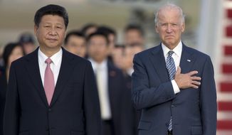 In this Sept. 24, 2015, file photo, Chinese President Xi Jinping, Vice President Joe Biden, stand for the U.S. national anthem during an arrival ceremony in Andrews Air Force Base, Md. (AP Photo/Carolyn Kaster, File)