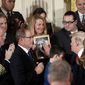 In this Oct. 26, 2017, file photo, Jeanne Moser, center, of East Kingston, N.H., watches as President Donald Trump reaches out to touch a photo of her son, Adam Moser, during an event to declare the opioid crisis a national public health emergency in the East Room of the White House in Washington. Adam was 27 when he died from an apparent fentanyl overdose. The coronavirus outbreak and the Trump administration&#39;s response to the pandemic have been a dominating theme in this year&#39;s presidential race. That has overshadowed debate over how to handle the nation&#39;s drug overdose crisis, which has contributed to the deaths of more than 470,000 Americans over the last two decades. (AP Photo/Pablo Martinez Monsivais, File)
