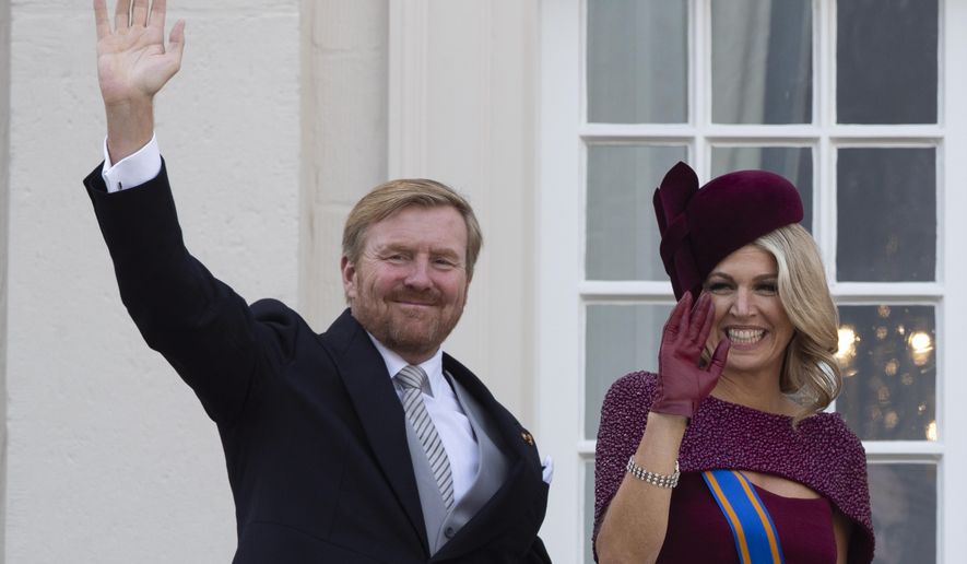 FILE - In this Tuesday, Sept. 17, 2019 file photo, Dutch King Willem-Alexander and Queen Maxima wave from the balcony of royal palace Noordeinde in The Hague, Netherlands. The Dutch king issued a video message Wednesday saying "with sorrow in the heart" that he regrets flying to Greece for a family vacation last week, a trip that was quickly broken off amid public uproar back home where people are being urged to stay home as much as possible to battle the coronavirus. (AP Photo/Peter Dejong, File)