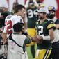 Tampa Bay Buccaneers quarterback Tom Brady, left, shakes hands with Green Bay Packers quarterback Aaron Rodgers after the Bucs defeated the Packers during an NFL football game Sunday, Oct. 18, 2020, in Tampa, Fla. (AP Photo/Mark LoMoglio)