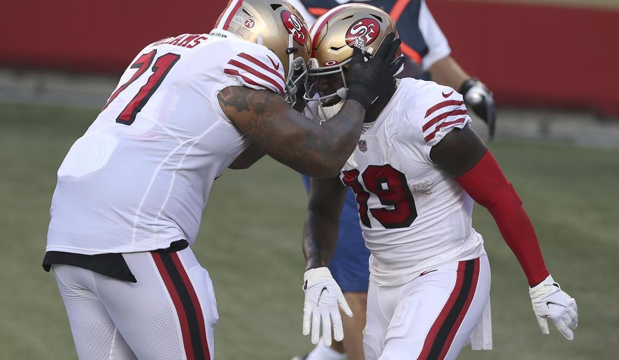 San Francisco 49ers wide receiver Deebo Samuel, right, is congratulated by Trent Williams after scoring a touchdown against the Los Angeles Rams during the first half of an NFL football game in Santa Clara, Calif., Sunday, Oct. 18, 2020. (AP Photo/Jed Jacobsohn)