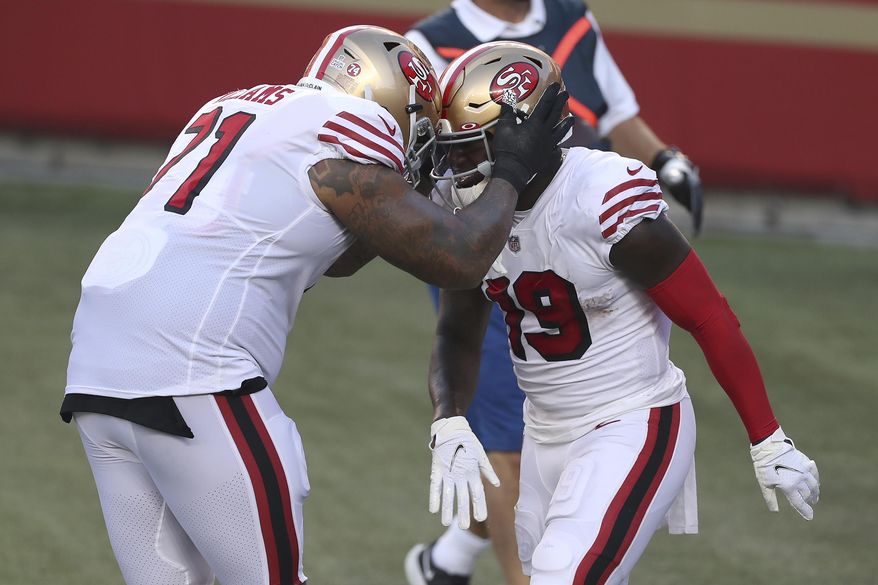 San Francisco 49ers wide receiver Deebo Samuel, right, is congratulated by Trent Williams after scoring a touchdown against the Los Angeles Rams during the first half of an NFL football game in Santa Clara, Calif., Sunday, Oct. 18, 2020. (AP Photo/Jed Jacobsohn)