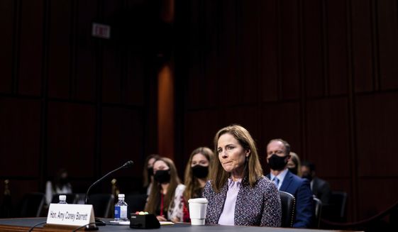 FILE - In this Oct. 14, 2020, file photo, Supreme Court nominee Amy Coney Barrett listens during a confirmation hearing before the Senate Judiciary Committee on Capitol Hill in Washington. Barrett served for nearly three years on the board of a private Christian school that effectively barred admission to children of same-sex parents and made it plain openly gay and lesbian teachers weren’t welcome in the classroom. (Erin Schaff/The New York Times via AP, Pool, File)
