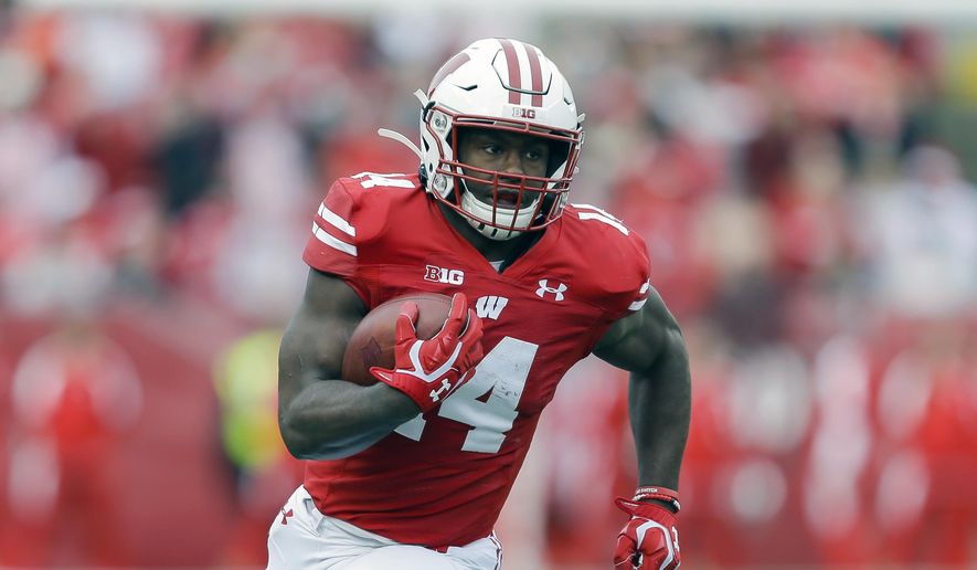 FILE - In this Oct. 12, 2019, file photo, Wisconsin running back Nakia Watson (14) carries during the first half of an NCAA college football game in Madison, Wis. Wisconsin’s rushing attack will look quite a bit different this season without Jonathan Taylor in the backfield. Wisconsin begins adjusting to life without Taylor on Friday night, Oct. 23, 2020, when the 14th-ranked Badgers host Illinois in their pandemic-delayed season opener.(AP Photo/Andy Manis, File)