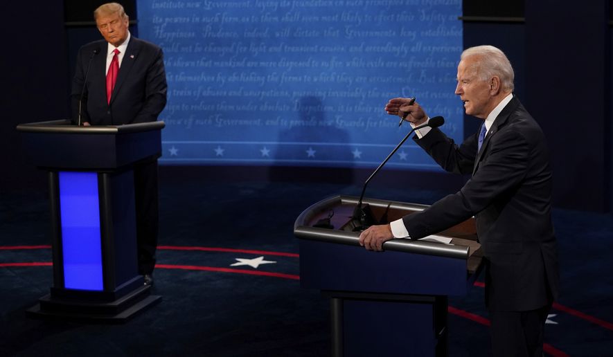 Democratic presidential candidate former Vice President Joe Biden answers a question as President Donald Trump listens during the second and final presidential debate Thursday, Oct. 22, 2020, at Belmont University in Nashville, Tenn. (AP Photo/Morry Gash, Pool)
