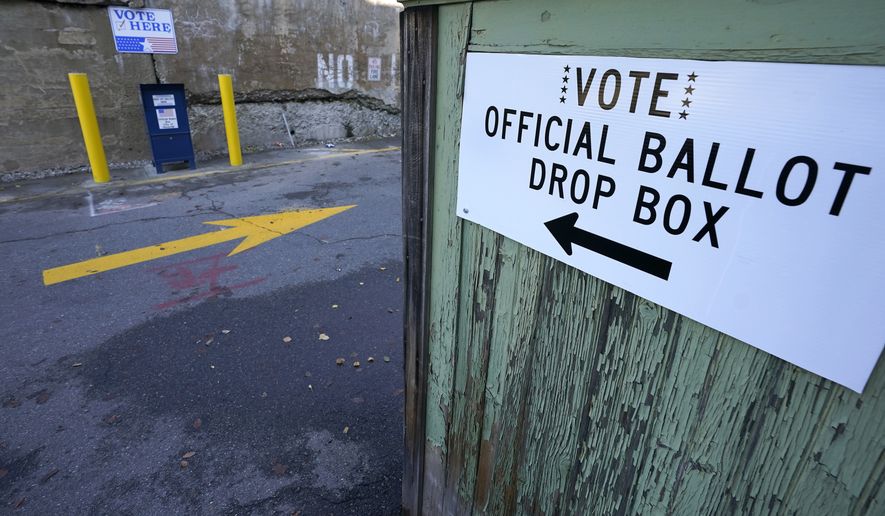 A ballot drop box is stationed outside Haverhill City Hall during early voting, Thursday, Oct. 22, 2020, in Haverhill, Mass. (AP Photo/Elise Amendola)