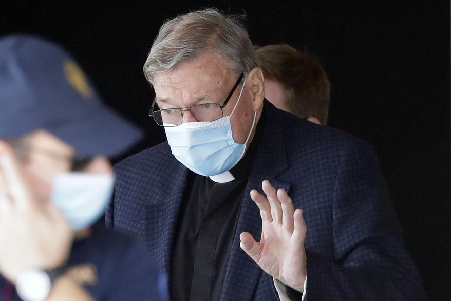 FILE - In this Sept. 30, 2020, file photo, Australian Cardinal George Pell waves as he arrives at Rome&#39;s international airport in Fiumicino. Australian state police said Friday, Oct. 23, 2020 it was not investigating the transfer of money from the Vatican to Australia, throwing doubt on Italian media speculation that it might be linked to the overturned convictions of Cardinal George Pell for child sex abuse. (AP Photo/Andrew Medichini, File)