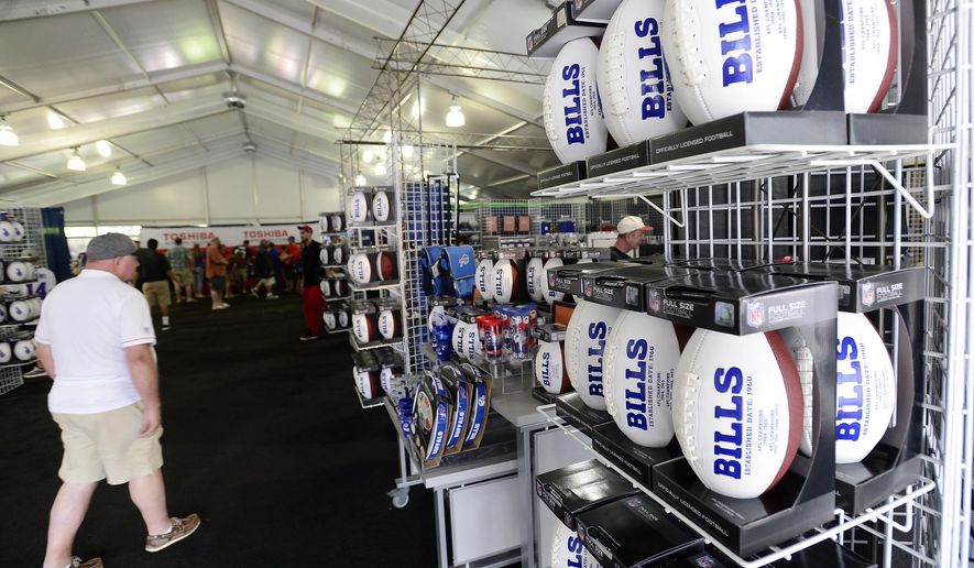 FILE - In this July 27, 2017, file photo, fans shop in the merchandise tent on opening day of Buffalo Bills NFL football training camp in Pittsford, N.Y. The Mafia is becoming legitimate in Buffalo — the Bills Mafia that is. The Bills last week filed an application to trademark its fanbase’s adopted nickname in preparation to launch a series of branded merchandise and apparel available at its team store and sold online. (AP Photo/Adrian Kraus, File)