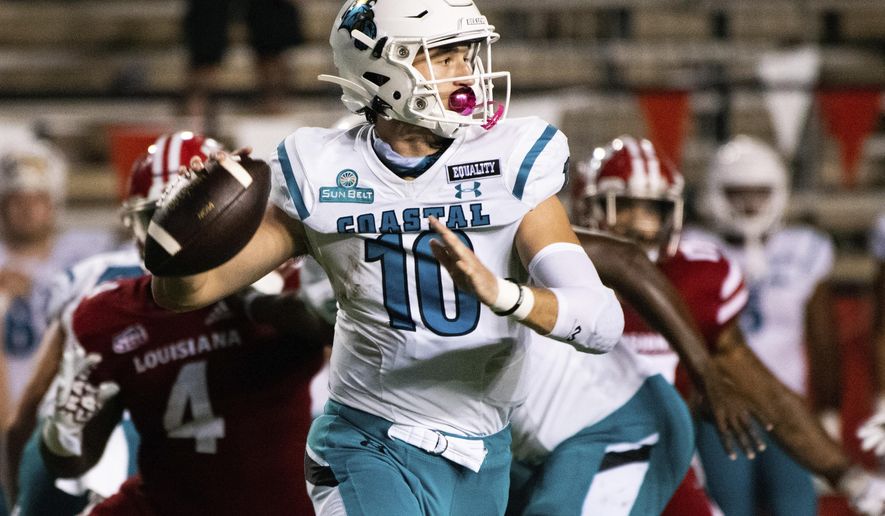 Coastal Carolina quarterback Grayson McCall (10) looks to pass during the first half of an NCAA football game against Louisiana-Lafayette in Lafayette, La., Wednesday, Oct. 14, 2020. (AP Photo/Paul Kieu)