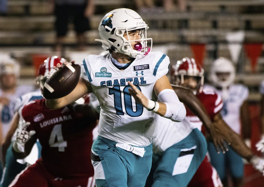 Coastal Carolina quarterback Grayson McCall (10) looks to pass during the first half of an NCAA football game against Louisiana-Lafayette in Lafayette, La., Wednesday, Oct. 14, 2020. (AP Photo/Paul Kieu)