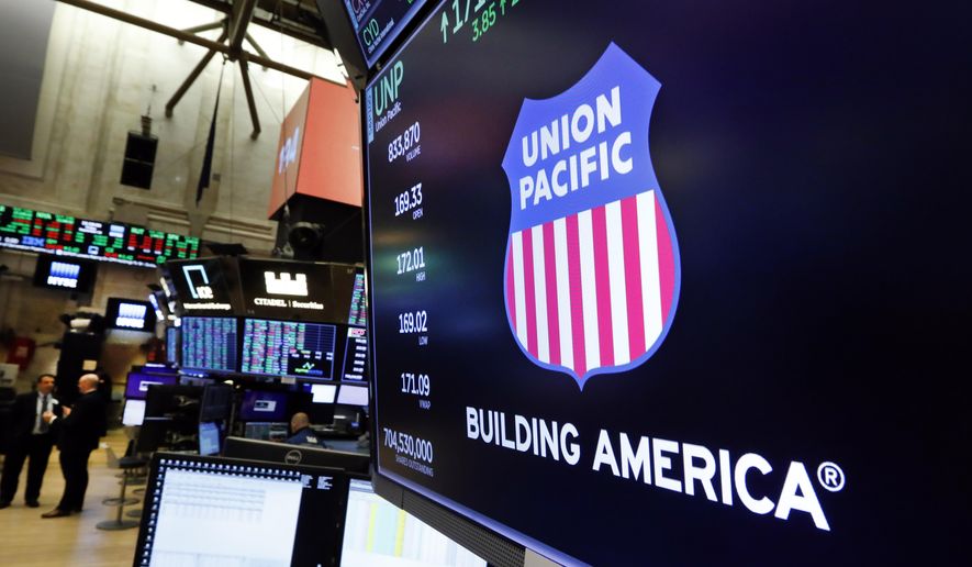 In this Sept. 13, 2019, file photo the logo for Union Pacific appears above a trading post on the floor of the New York Stock Exchange.  On Nov. 17, 2020, the company announced it would give a $1,000 bonus to its employees next month in gratitude for their hard work during the COVID pandemic. (AP Photo/Richard Drew, File)  **FILE**