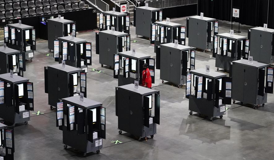 A man tries to vote early but can&#39;t because the machines stopped working during early voting at the State Farm Arena on Monday, Oct. 12, 2020, in Atlanta. (AP Photo/Brynn Anderson)