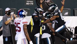 Philadelphia Eagles players celebrate after a touchdown by Boston Scott during the second half of an NFL football game against the New York Giants, Thursday, Oct. 22, 2020, in Philadelphia. (AP Photo/Chris Szagola)