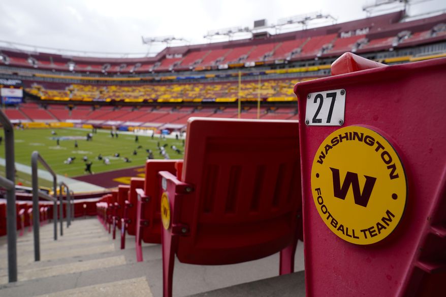 In this Sunday, Sept. 13, 2020, file photo, seats at Fedex Field display the Washington Football Team logo during pregame warmups of an NFL football game between Washington Football Team and Philadelphia Eagles, in Landover, Md. (AP Photo/Susan Walsh, File)