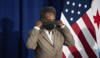 Chicago Mayor Lori Lightfoot wears her mask after speaking about Chicago Public Schools&#39; during a press conference at City Hall in Chicago, Aug. 5, 2020. (Pat Nabong/Chicago Sun-Times via AP) ** FILE ** 