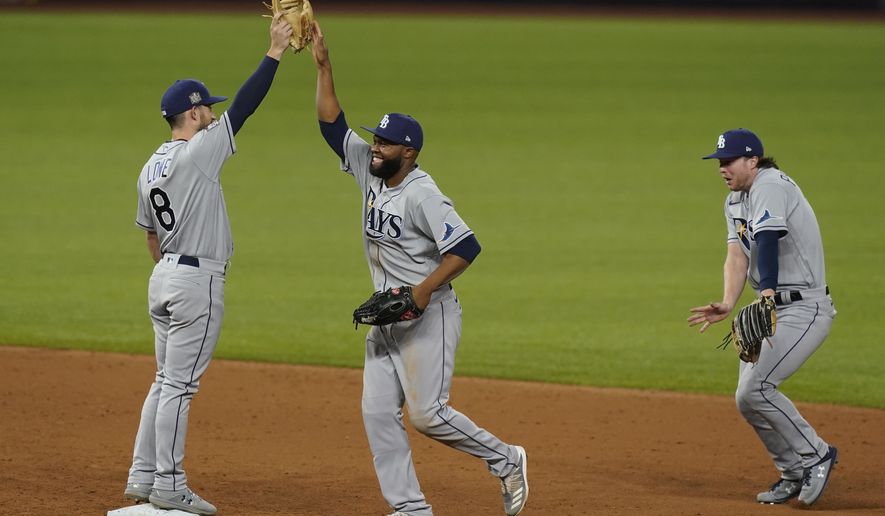 The Tampa Bay Rays celebrates their win against the Los Angeles Dodgers in Game 2 of the baseball World Series Wednesday, Oct. 21, 2020, in Arlington, Texas. Ray beat the Dodgers 6-4.(AP Photo/Eric Gay)
