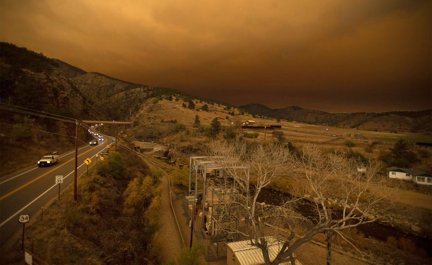 Evacuees drive through a traffic jam exiting Big Thompson Canyon along U.S. Highway 34 as the East Troublesome Fire, now the second largest in Colorado history, forces residents out of Estes Park near Loveland, Colo., on Thursday, Oct. 22, 2020. (Bethany Baker/The Coloradoan via AP)