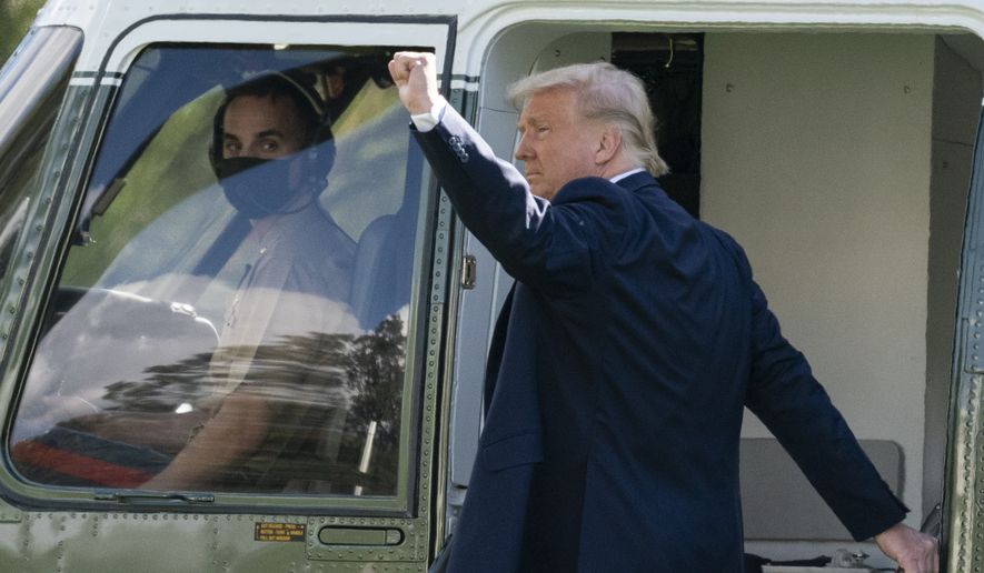 President Donald Trump pumps his fist as he boards Marine One on the South Lawn of the White House, Friday, Oct. 23, 2020, in Washington. Trump is en route to Florida. (AP Photo/Alex Brandon)