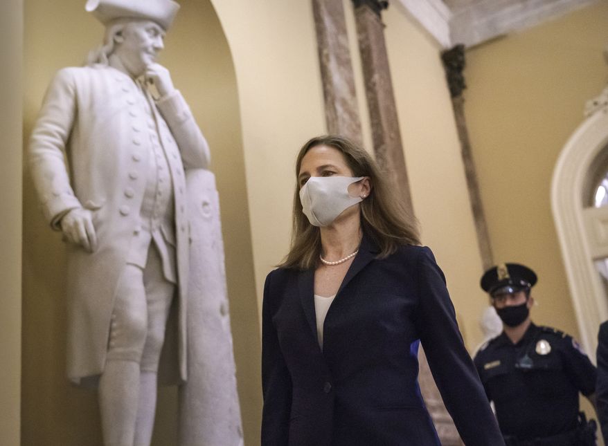 Judge Amy Coney Barrett, President Donald Trump&#39;s nominee for the Supreme Court, arrives for closed meetings with senators, at the Capitol in Washington, Wednesday, Oct. 21, 2020. (AP Photo/J. Scott Applewhite)